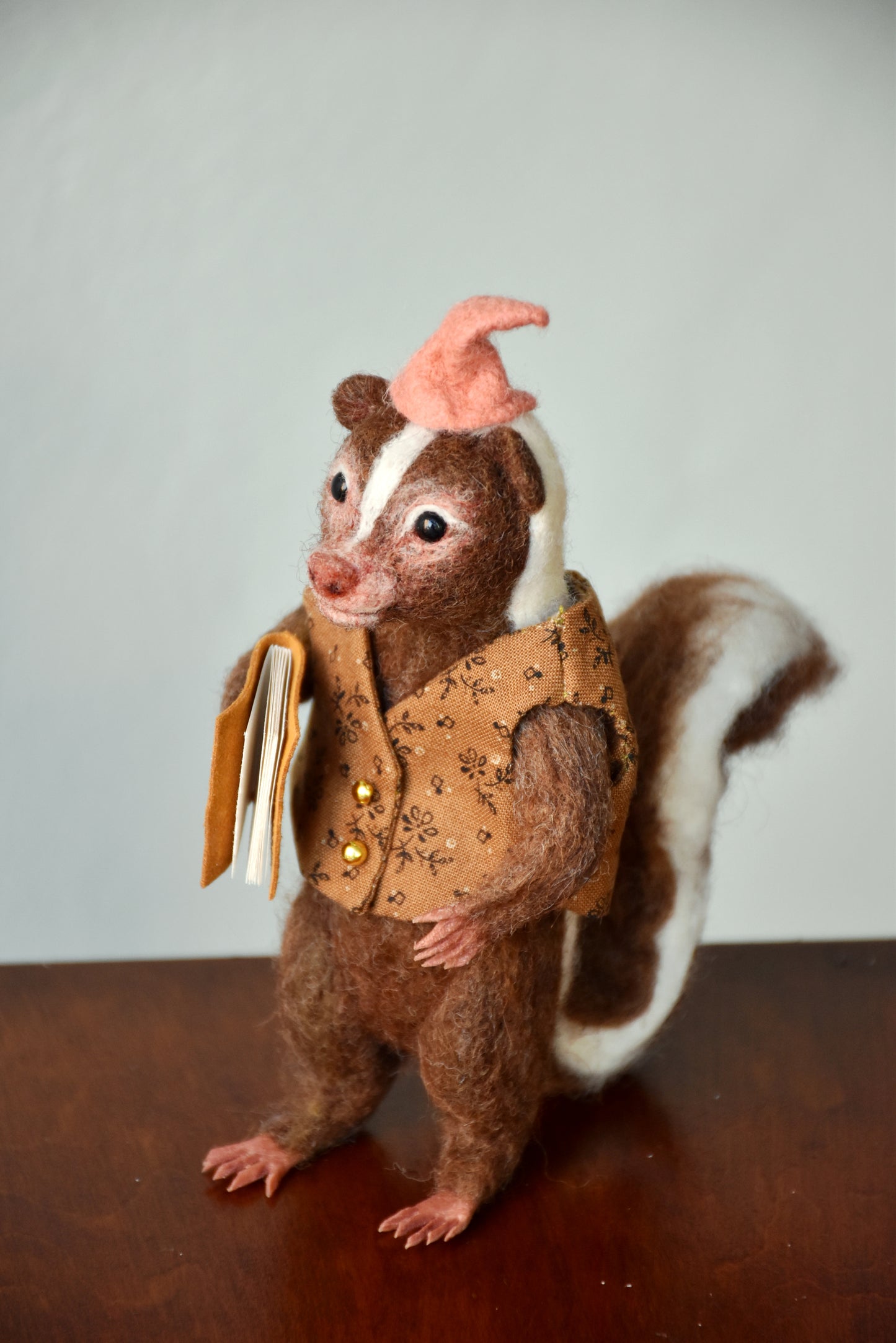 Needle Felted Wanderer Reader Brown Skunk