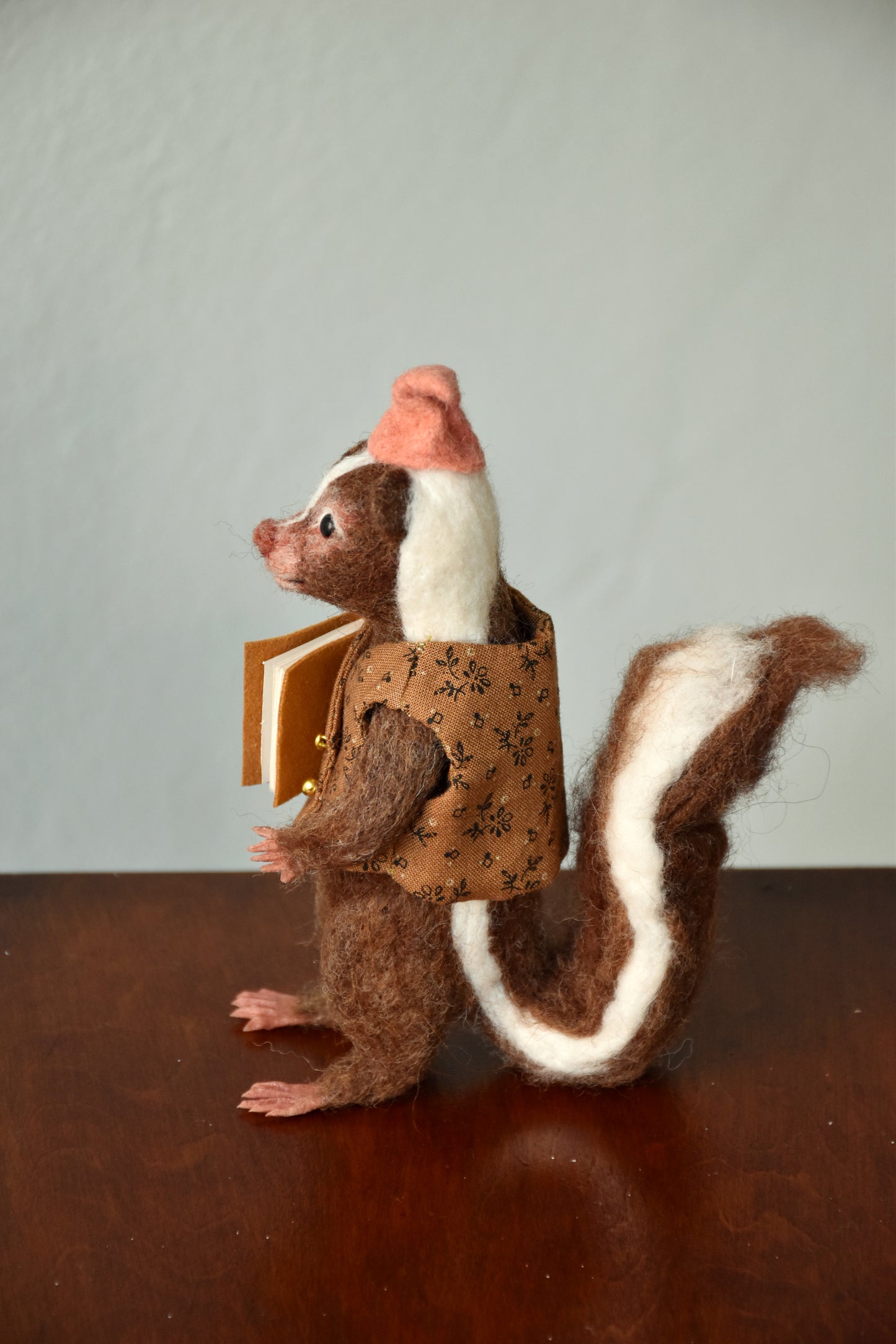 Needle Felted Wanderer Reader Brown Skunk