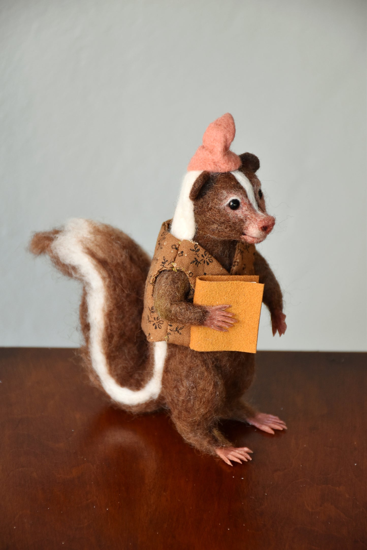 Needle Felted Wanderer Reader Brown Skunk